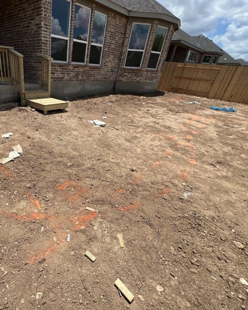 Before view of a Bulverde backyard prior to custom hardscape and patio construction