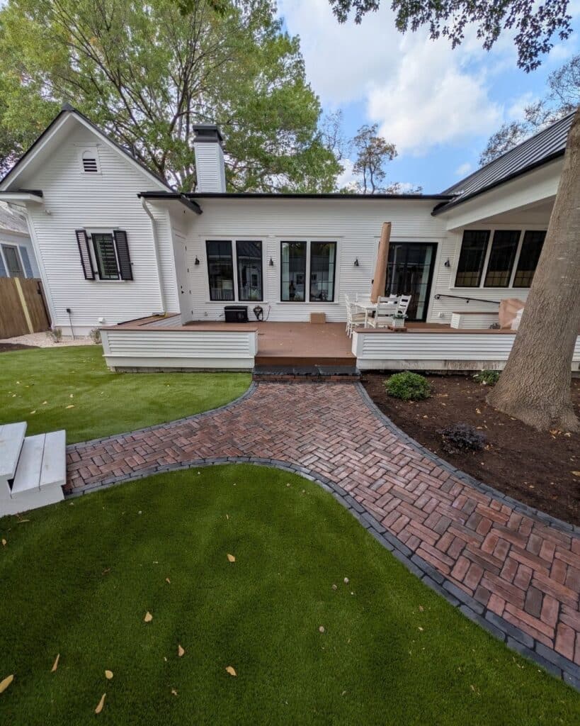 Sweeping curved backyard walkway featuring a Double Herringbone pattern with Unilock Copthorne pavers