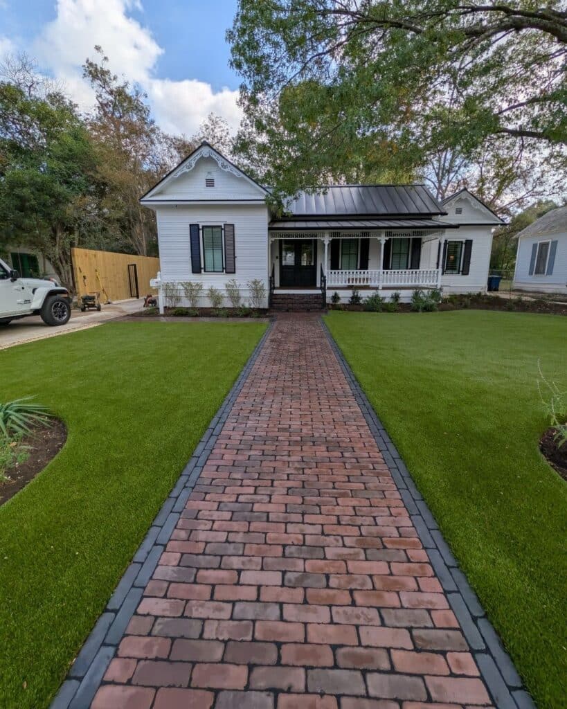 Wide 6-foot main entrance walkway featuring a running bond inlay with a double sailor course border in Black Basalt