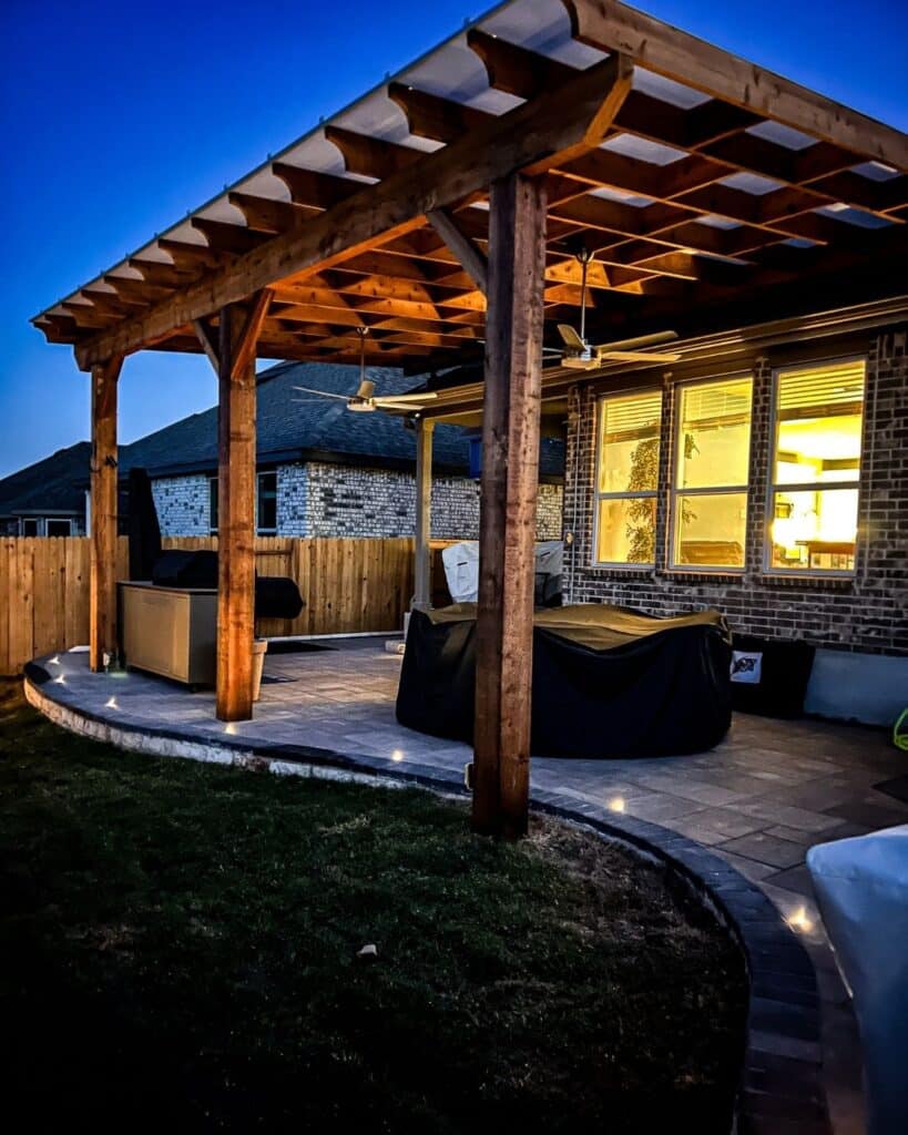 Custom outdoor living space in Bulverde featuring a patio and evening accent lighting