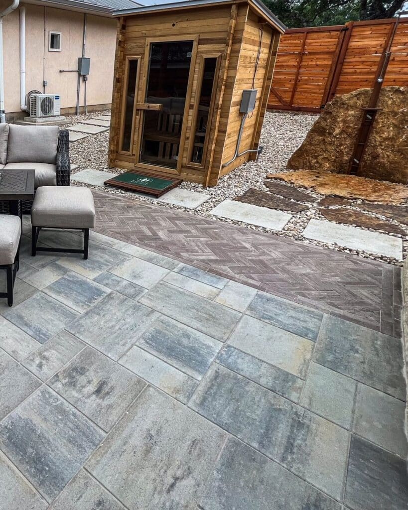 Complete outdoor retreat featuring a cedar sauna and hot tub area anchored on a precision-leveled Unilock paver system