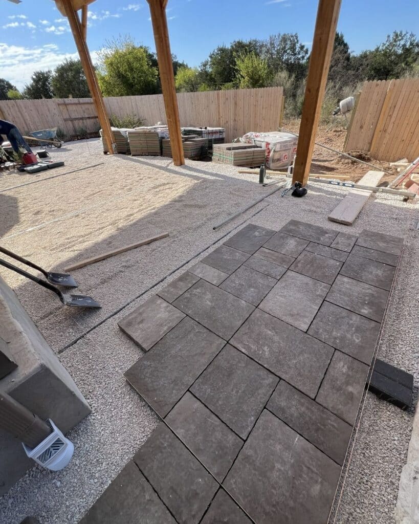 View of the open-grade base and leveling process for a premium paver installation in Bulverde