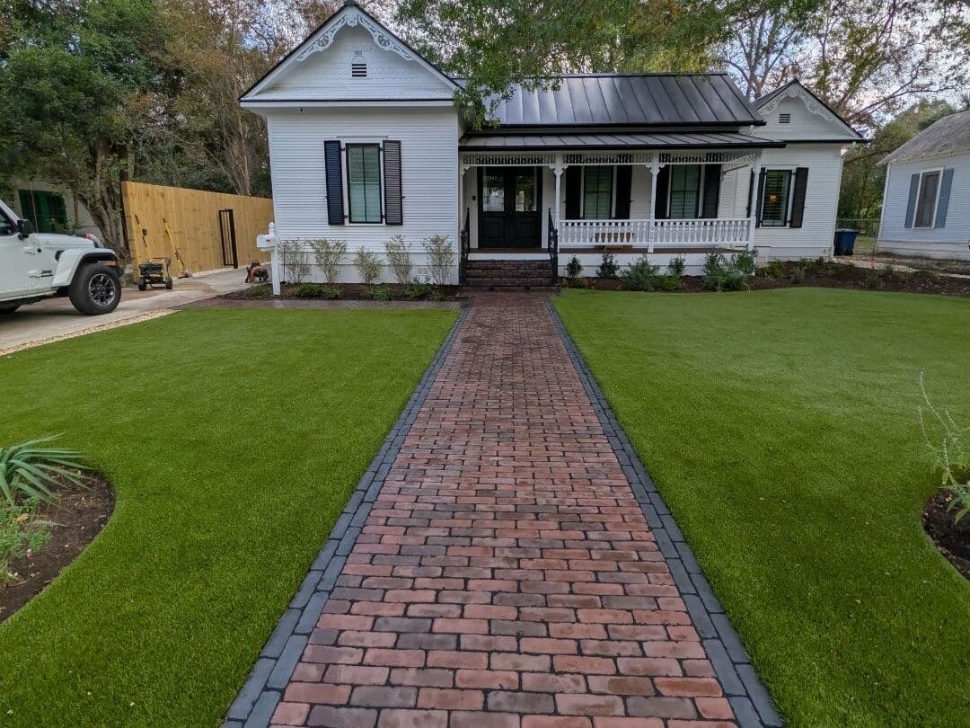 Wide 6-foot main entrance walkway featuring a running bond inlay with a double sailor course border in Black Basalt